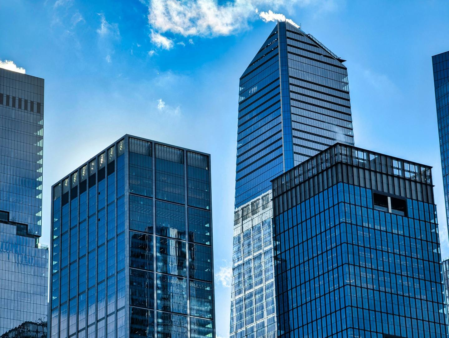 NYC commercial building exteriors — the kind of properties WhoodenSecurity secures